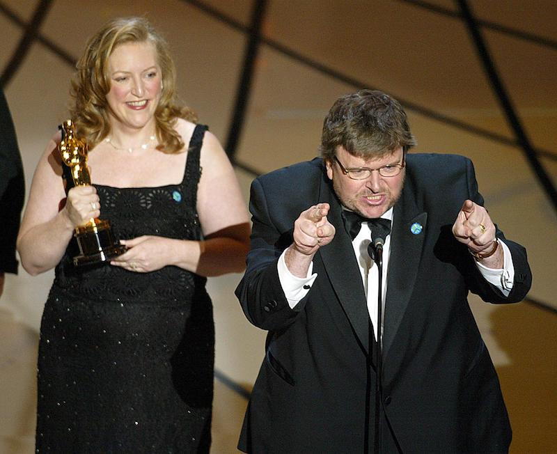 Filmmaker Michael Moore accepts his Oscar for Documentry Feature for "Bowling for Columbine" during the 75th Academy Awards at the Kodak Theatre in Hollywood, California, 23 March 2003. AFP PHOTO TIMOTHY A. CLARY (Photo credit should read TIMOTHY A. CLARY/AFP/Getty Images)