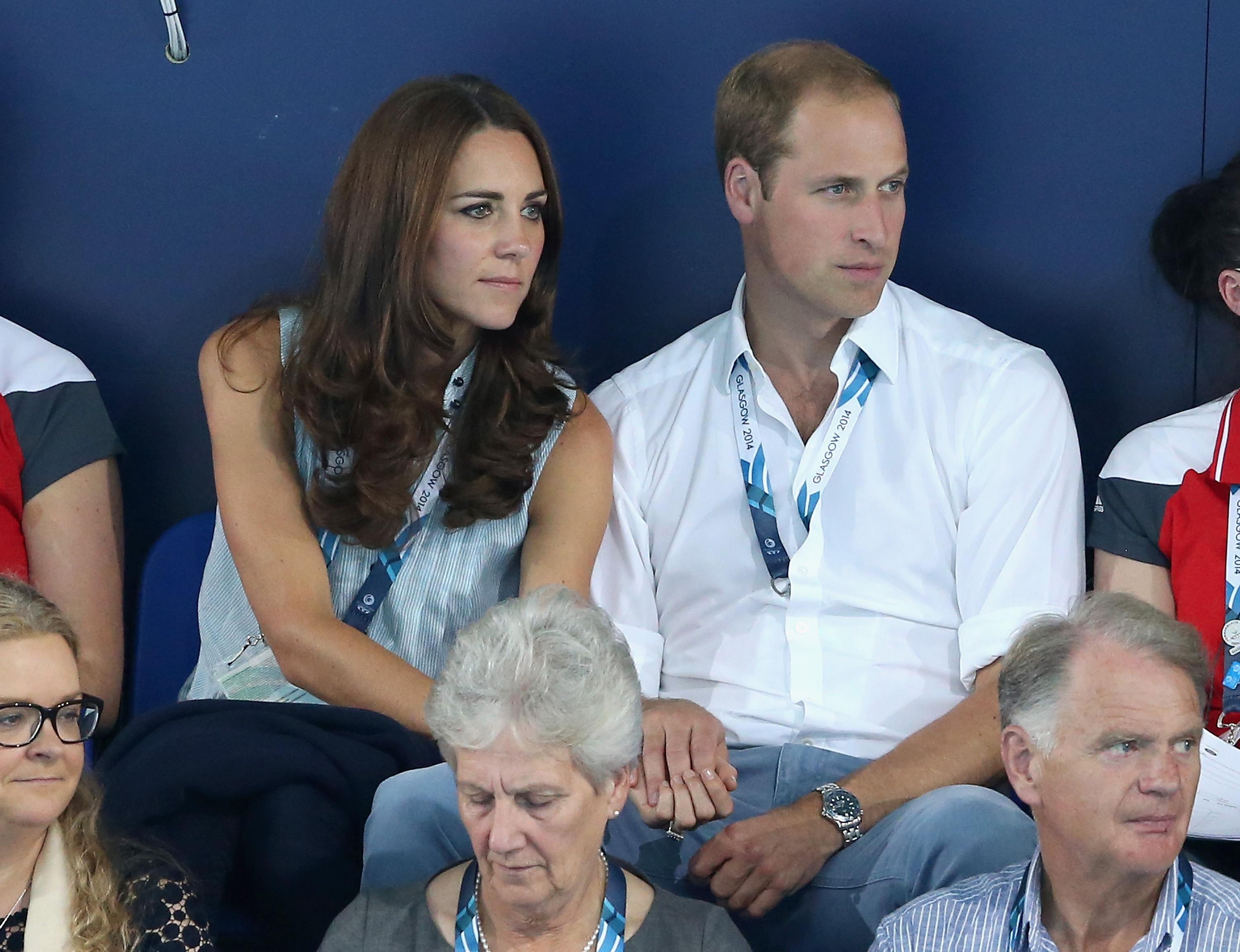 Catherine, Duchess of Cambridge and Prince William, Duke of Cambridge hold hands as they watch the swimming at Tollcross Swimming Centre during the 20th Commonwealth games on July 28, 2014 in Glasgow, Scotland. 