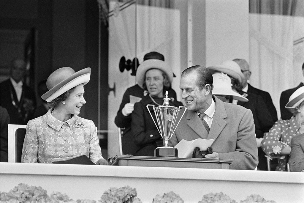 Britain's Queen Elizabeth II (2nd L) and her husband Prince Philip (2nd R), Duke of Edinburgh, share a smile in May 1972 as they attend a horse race at Longchamp racecourse, outside Paris during their five-day official visit in France.