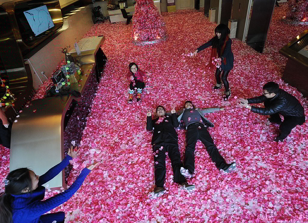 Single men and women toss peach petals to pray good luck for life and love on February 9, 2015 in Wuhan, Hubei province of China. A hall at the first floor of Wuhan's K11 Gourmet Tower scatterred peach petals to welcome the upcoming Valentine's Day which drew single men and women's interest. Single men and women toss peach petals to pray good luck for life and love on February 9, 2015 in Wuhan, Hubei province of China. A hall at the first floor of Wuhan's K11 Gourmet Tower scatterred peach petals to welcome the upcoming Valentine's Day which drew single men and women's interest.