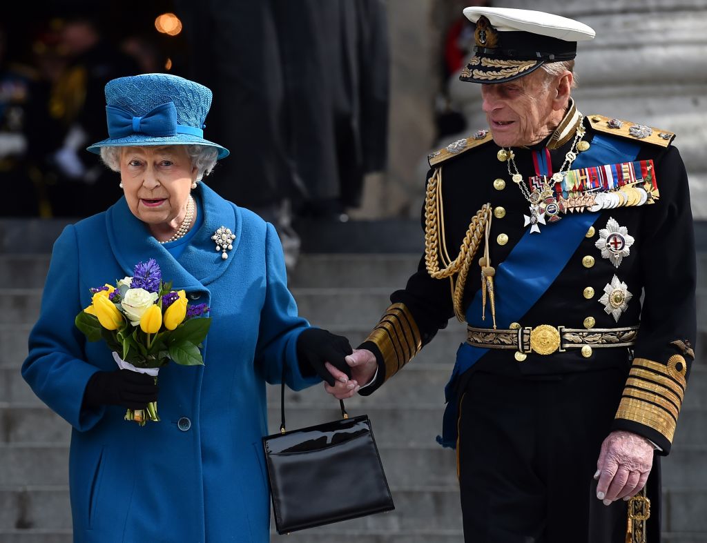 Queen Elizabeth and Prince Philip hold hands as they walk down steps. Queen Elizabeth and Prince Philip hold hands as they walk down steps.