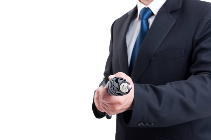 Business man, hitman or special secret agent holding umbrella like a rifle. Spy Weapons Business man, hitman or special secret agent holding umbrella like a rifle. Spy Weapons