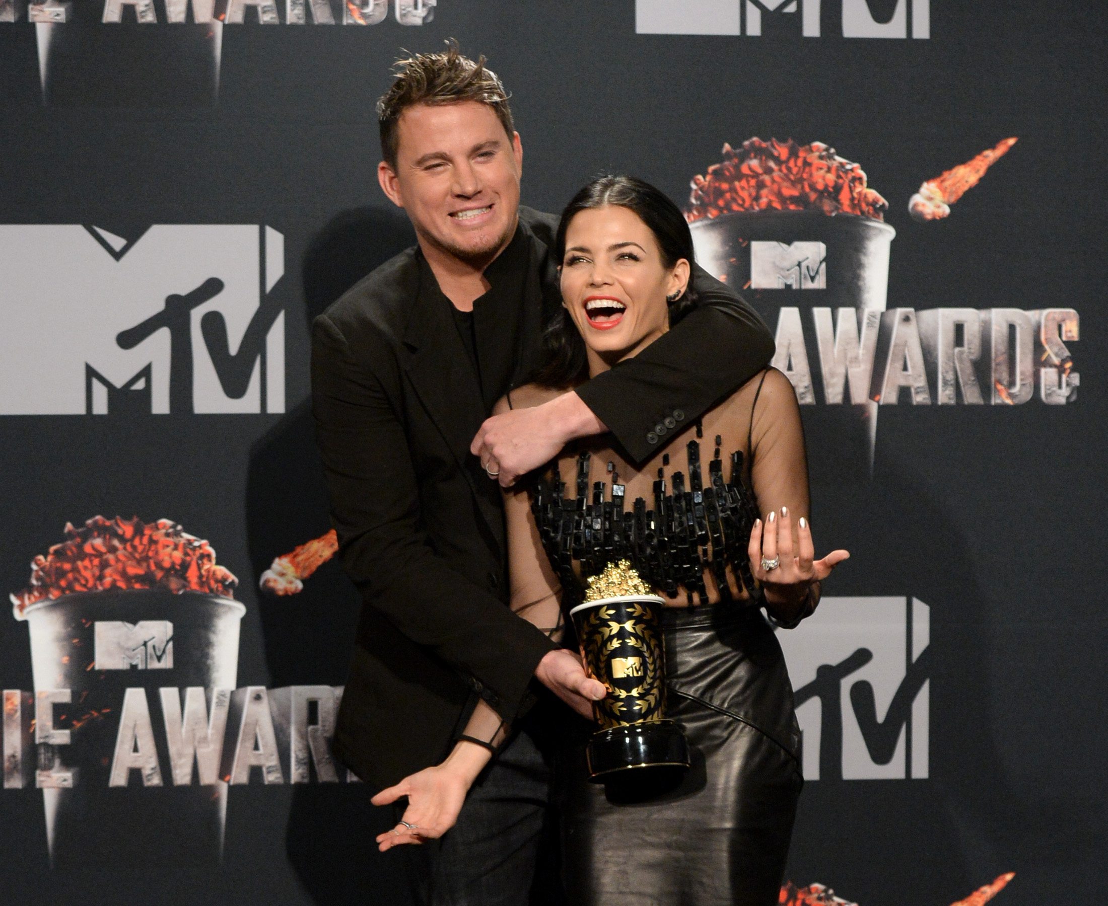 Honoree Channing Tatum (L, holding Trailblazer Award) and actress Jenna Dewan Tatum pose in the press room during the 2014 MTV Movie Awards at Nokia Theatre L.A. Live on April 13, 2014 in Los Angeles, California. 
