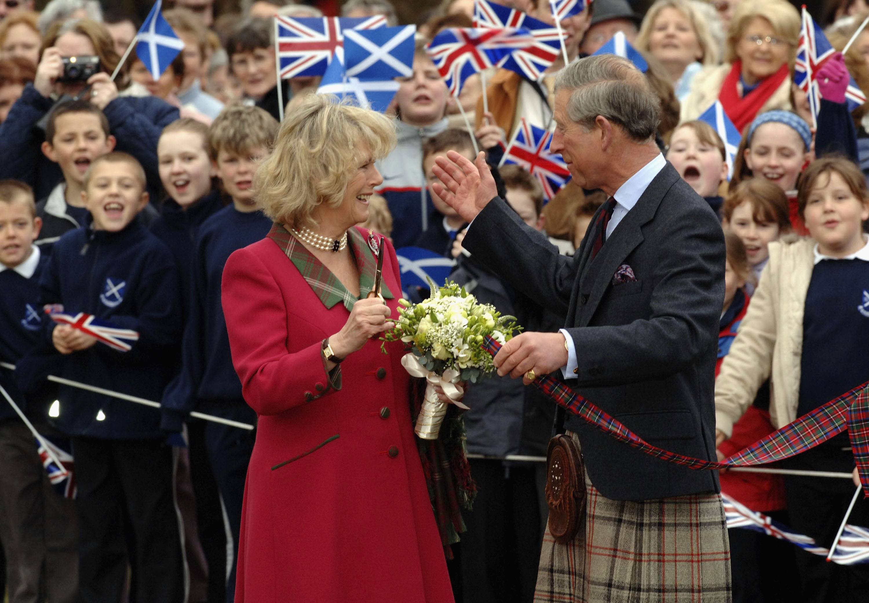 TRH Prince Charles, the Prince of Wales, and his wife Camilla, the Duchess of Cornwall, in their role as the Duke and Duchess of Rothesay, take time out from their honeymoon at Birkhall on the Queen's Aberdeenshire estate, to undertake their first joint official engagement opening Monaltrie Park children's playground in Ballater near Balmoral on April 14, 2005 in Aberdeenshire, Scotland.