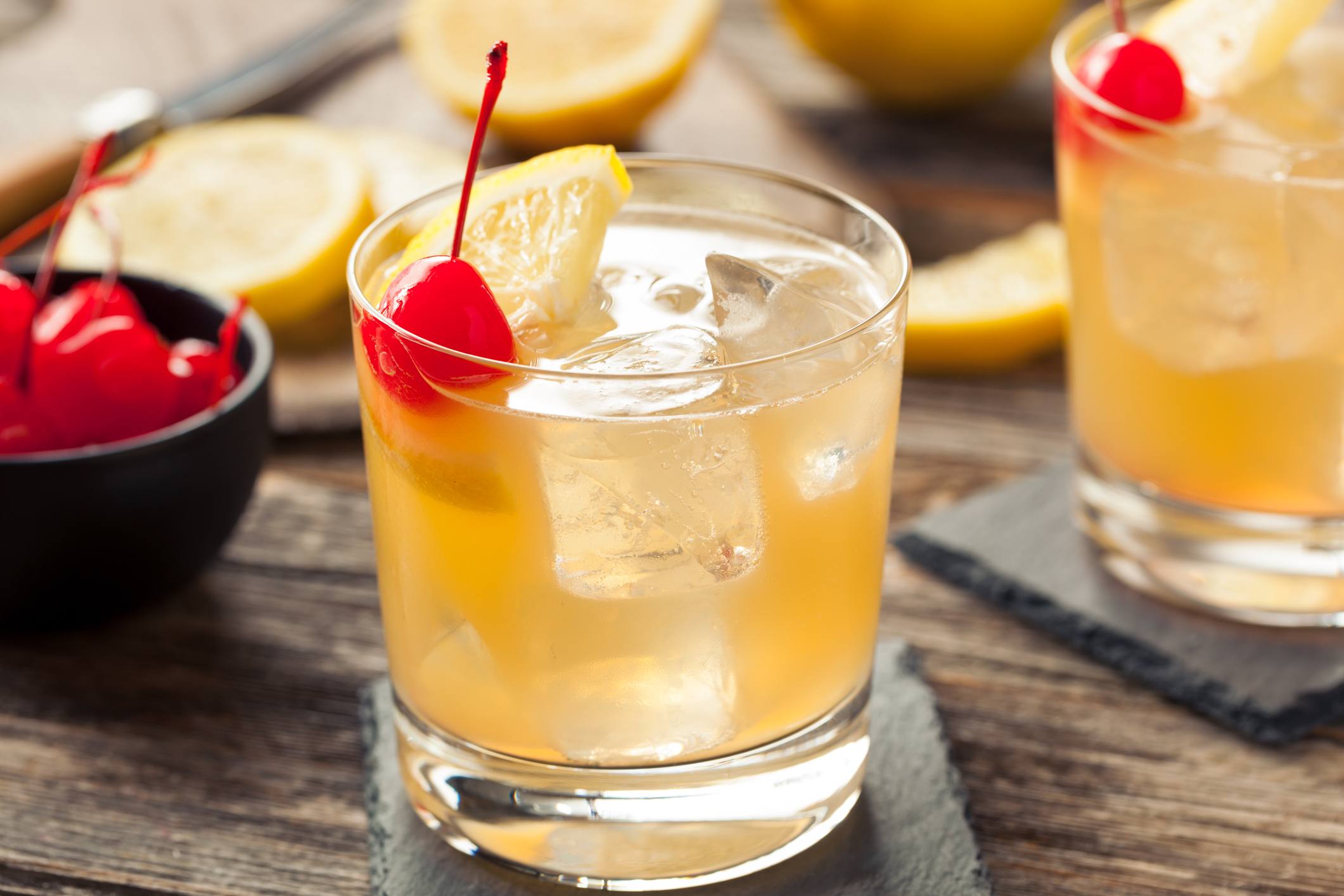 Homemade Whiskey Sour Cocktail Drink with a Cherry Lemon Homemade Whiskey Sour Cocktail Drink with a Cherry Lemon