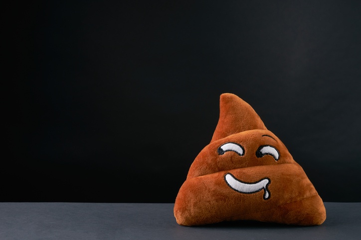 Poop emoticon on black background with copy space. Spy Weapons. Poop emoticon on black background with copy space. Spy Weapons.