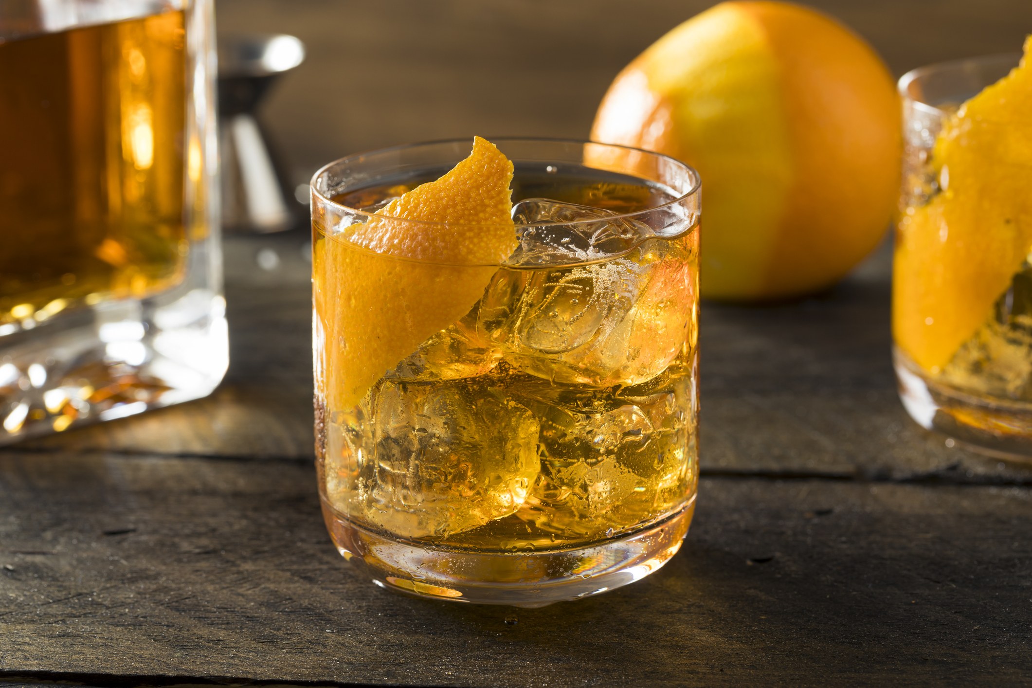 Homemade Old Fashioned Bourbon on the Rocks with an Orange Garnish Homemade Old Fashioned Bourbon on the Rocks with an Orange Garnish