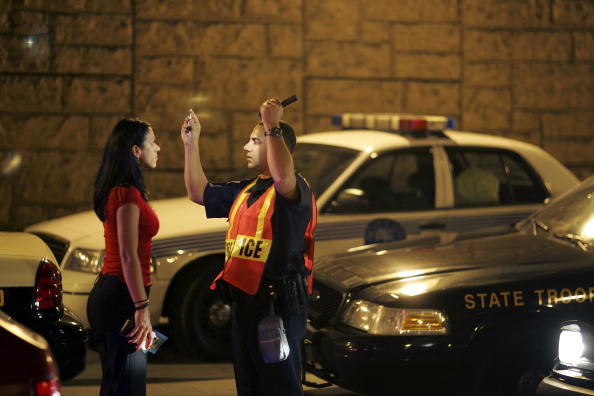 Officer Kevin Millan from the City of Miami Beach police department conducts a field sobriety test at a DUI traffic checkpoint December 15, 2006 in Miami, Florida. According to police, the woman failed a breathalyzer test by blowing into the device and receiving two readings one at .190 the other .183, which is twice the legal limit in Florida. The city of Miami, with the help of other police departments, will be conducting saturation patrols and setting up checkpoints during the holiday period looking to apprehend drivers for impaired driving and other traffic violations. Officer Kevin Millan from the City of Miami Beach police department conducts a field sobriety test at a DUI traffic checkpoint December 15, 2006 in Miami, Florida. According to police, the woman failed a breathalyzer test by blowing into the device and receiving two readings one at .190 the other .183, which is twice the legal limit in Florida. The city of Miami, with the help of other police departments, will be conducting saturation patrols and setting up checkpoints during the holiday period looking to apprehend drivers for impaired driving and other traffic violations.