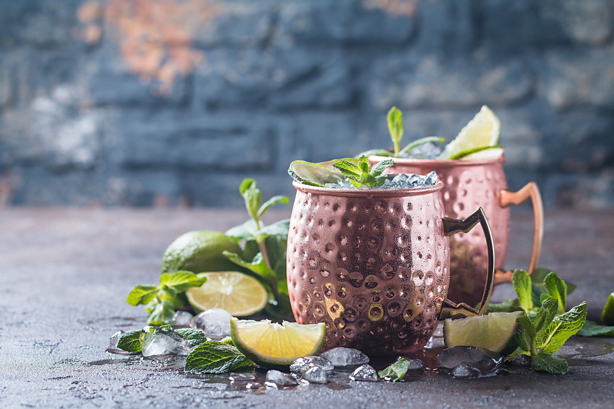 Moscow mule cocktail in copper cup with lime, ginger beer, vodka and mint garnish Moscow mule cocktail in copper cup with lime, ginger beer, vodka and mint garnish