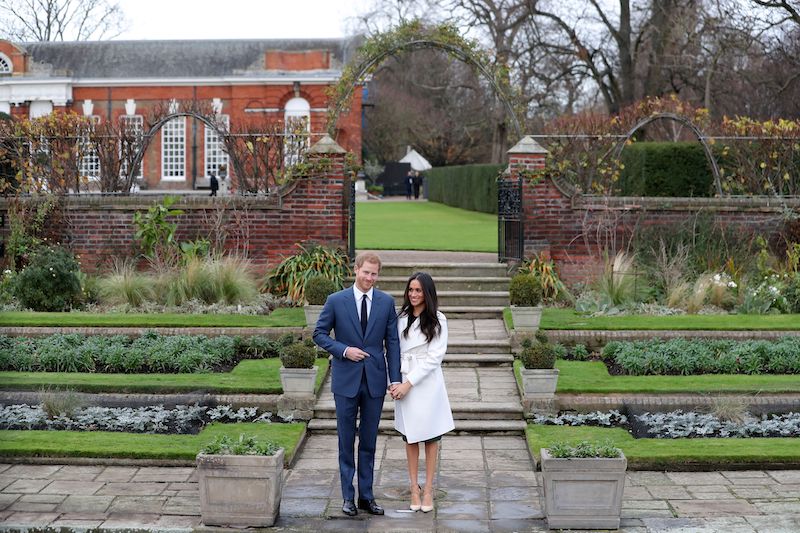 Britain's Prince Harry and his fiancée US actress Meghan Markle pose for a photograph in the Sunken Garden at Kensington Palace in west London on November 27, 2017, following the announcement of their engagement. Britain's Prince Harry and his fiancée US actress Meghan Markle pose for a photograph in the Sunken Garden at Kensington Palace in west London on November 27, 2017, following the announcement of their engagement.