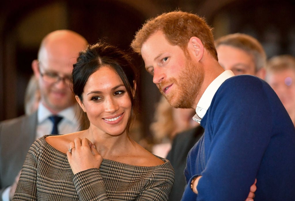 Prince Harry whispers to Meghan Markle Prince Harry whispers to Meghan Markle