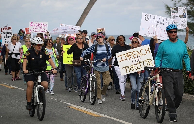 Palm Beach protesters march as Trump spends a weekend at Mar-a-Lago
