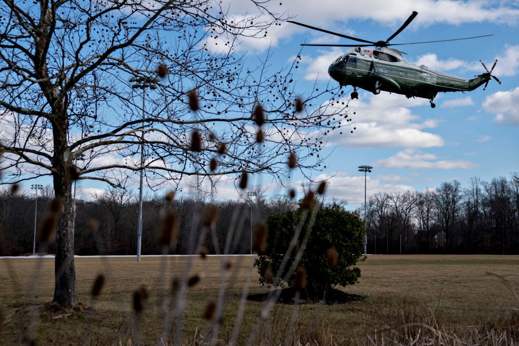 a military helicopter landing in a field a military helicopter landing in a field