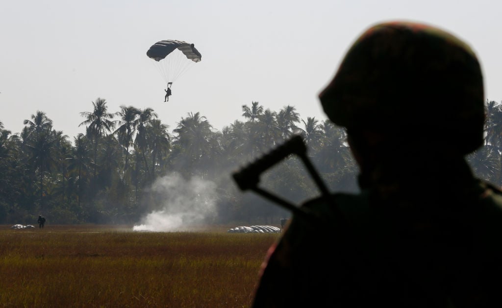 a parachute man lands during military exercises in myanmar