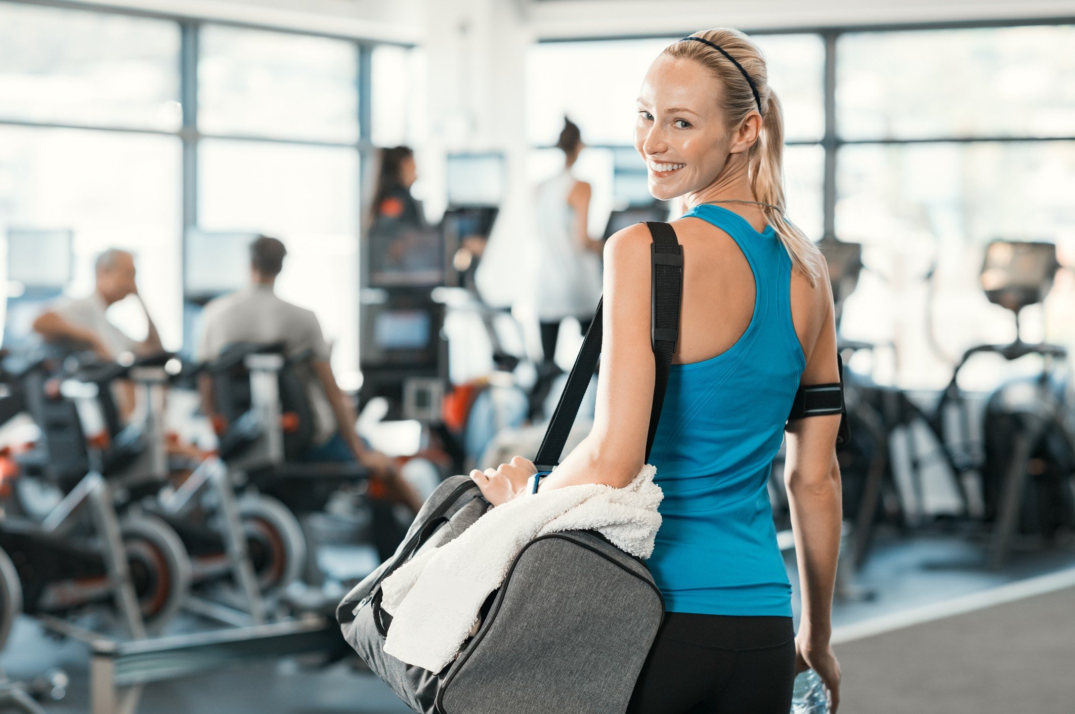 woman holding gym bag in a fitness centre. woman holding gym bag in a fitness centre.