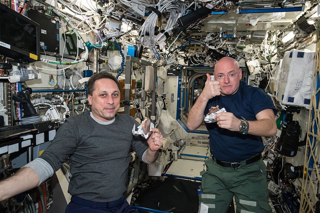 NASA astronaut Scott Kelly gives a thumbs up on the quality of his snack while taking a break from his work schedule