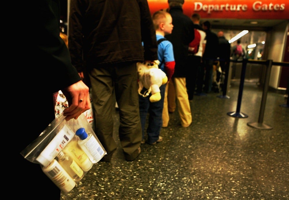 BAA employee holds a plastic bag with liquid containers