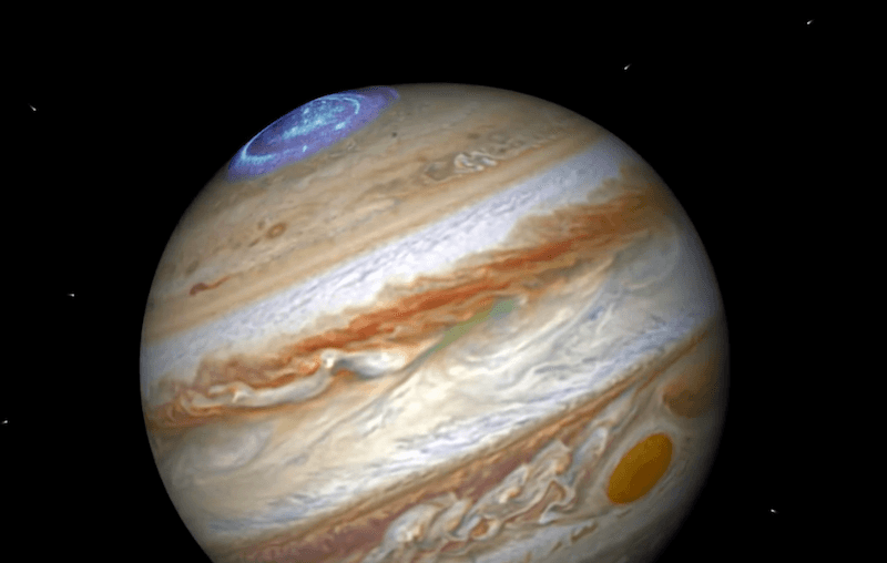 An image of Jupiter with a glowing blue auroras. An image of Jupiter with a glowing blue auroras.