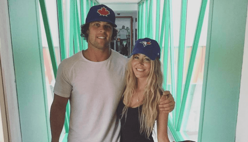 Kevin Wendt and his ex-girlfriend wearing matching baseball caps. 
