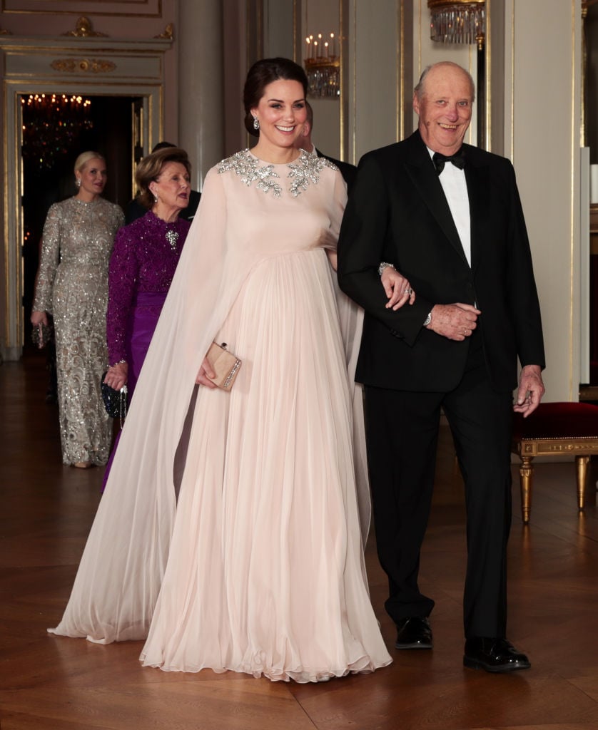 Britain's Catherine, Duchess of Cambridge walks with Norway's King Harald