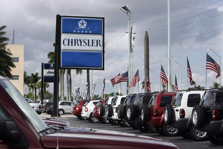 New cars for sale sit in a lot at a local Chrysler dealership