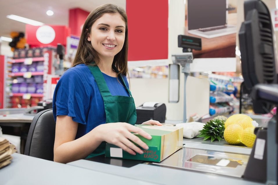 Portrait of woman cashier smiling at checkout