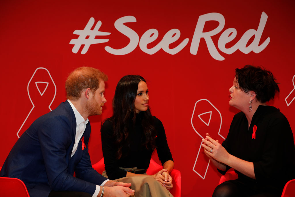 Britain's Prince Harry and his fiancee US actress Meghan Markle (C) take part in a discussion with HIV consultant doctor Laura Waters