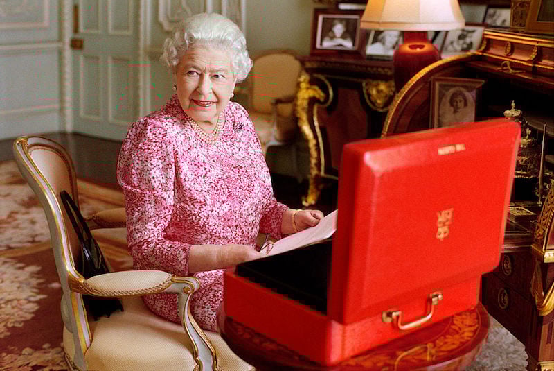 Queen Elizabeth II is seated at her desk in her private audience room at Buckingham Palace