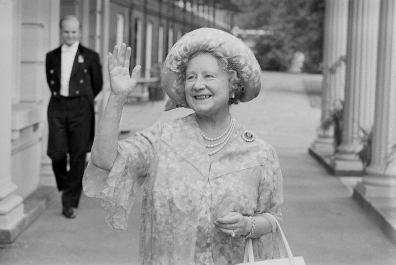 The Queen mother waving and smiling. 