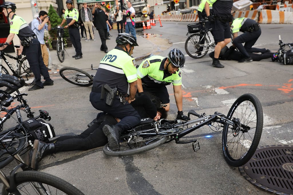 Man on the ground after Resisting arrest of police during a protest