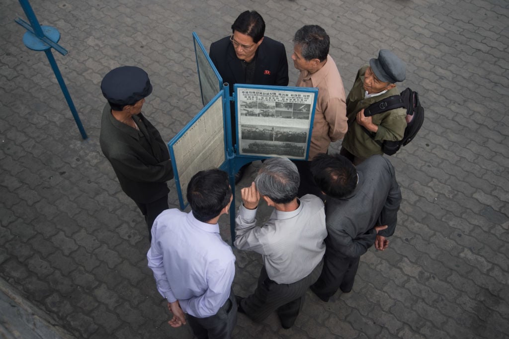 People read North Korean newspaper Rodong Sinmun