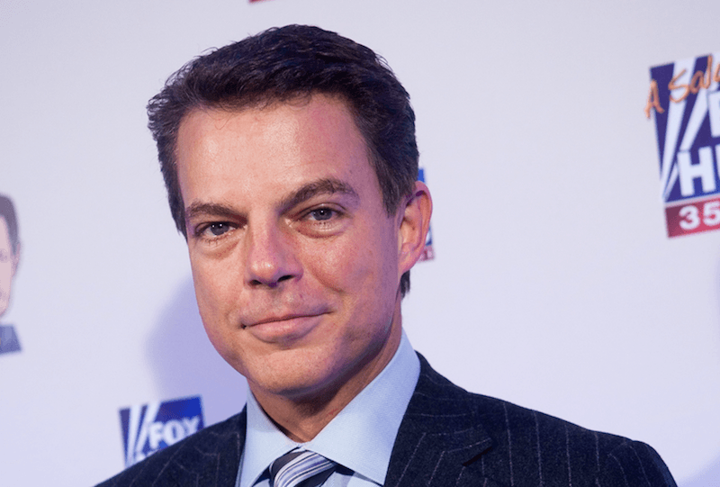 Shepard Smith smiling while on a red carpet. 
