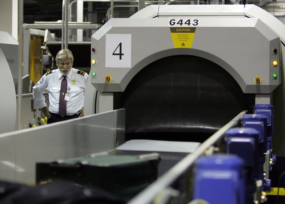 A Transportation Security Administration (TSA) worker monitors bags