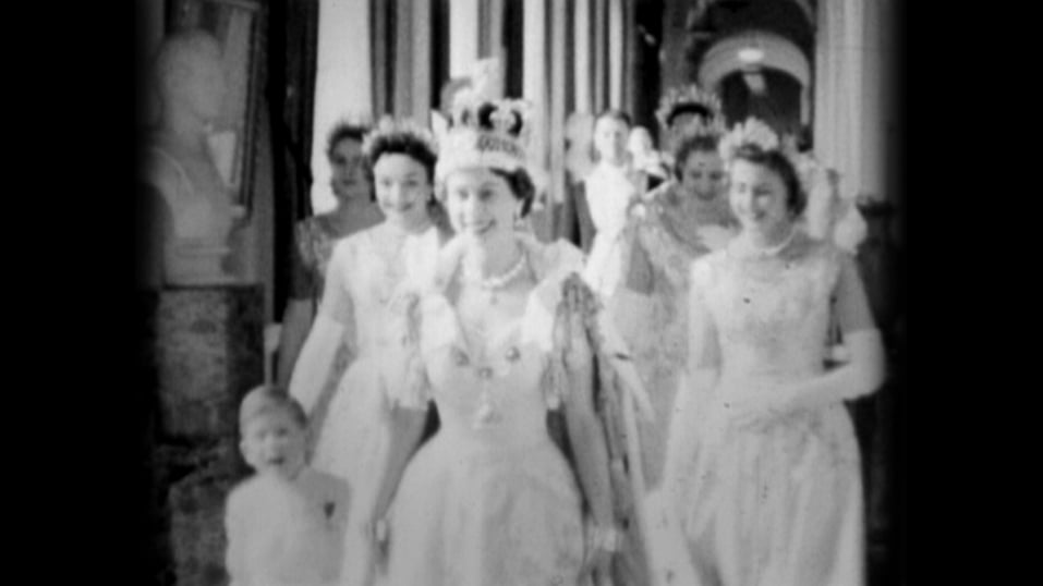 Queen Elizabeth II walks down the Principal Corridor with Prince Charles (L) on the day of her Coronation on June 02, 1953 in London, England
