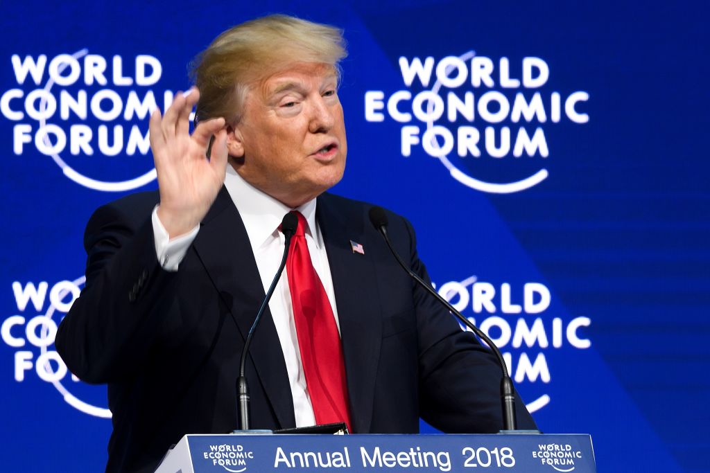 Donald Trump at World Economic Forum, speaking behind a podium. 