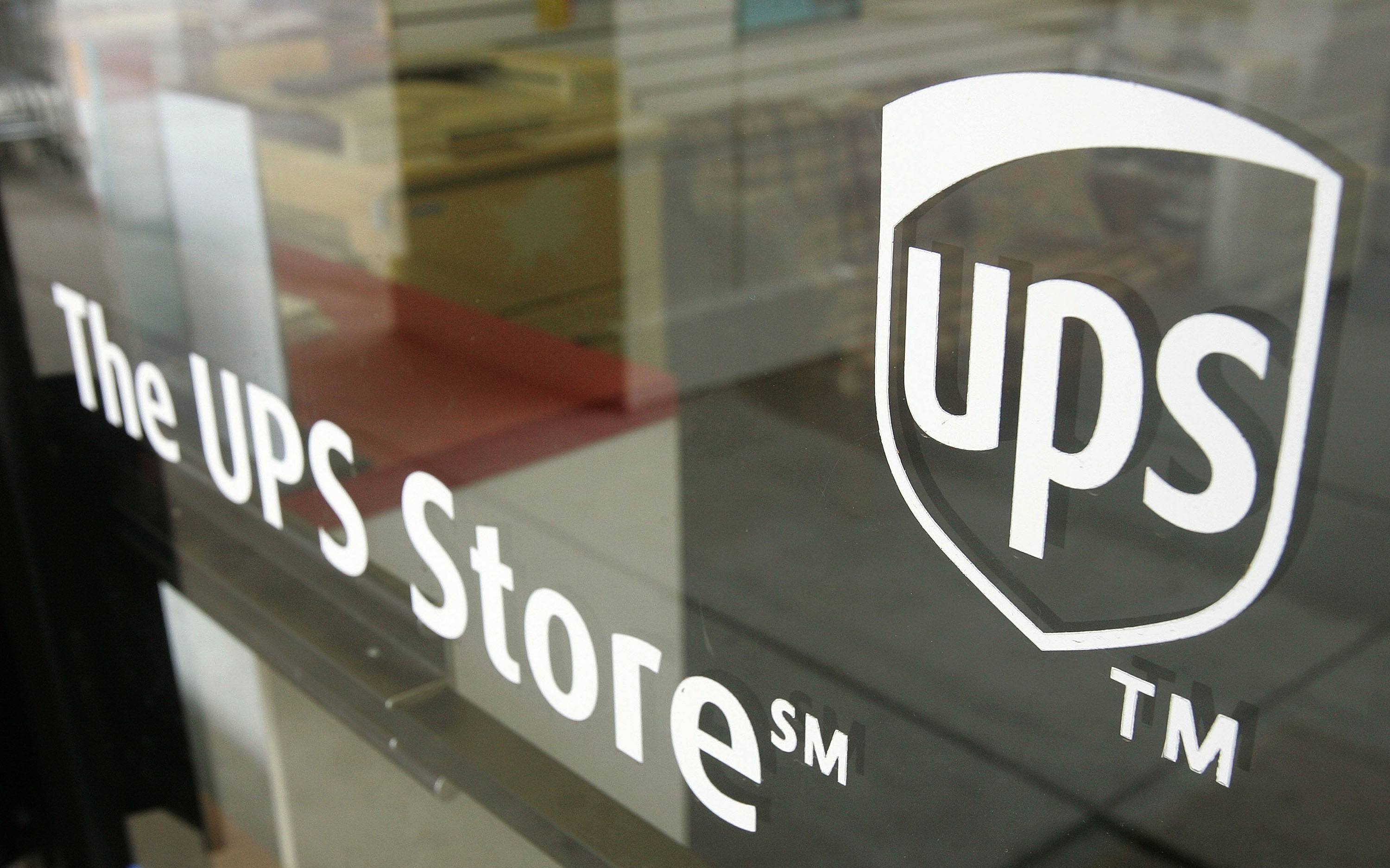 A UPS Store sign is seen on a door