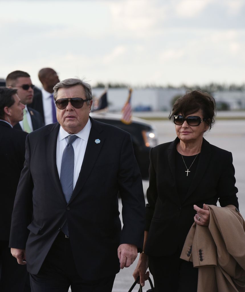 Viktor and Amalija Knavs make their way to a vehicle upon arrival at Palm Beach International Airport in West Palm Beach