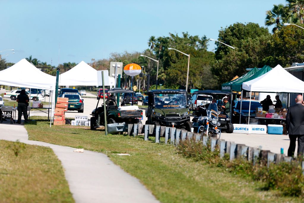 Police vehicles block the roadway to Marjory Stoneman Douglas High School in Parkland, Florida
