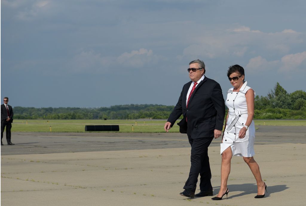 Viktor Knavs (L) and Amalija Knavs step off off Air Force One upon arrival in Morristown