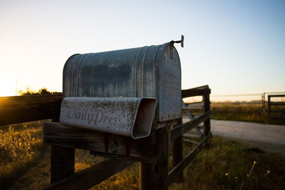 A metal, vintage mailbox with a slot for newspaper