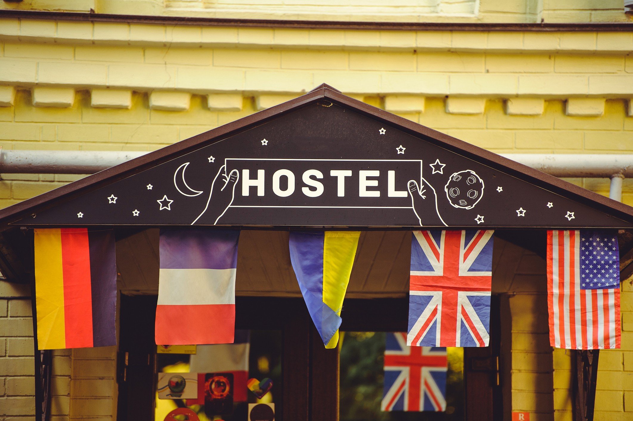 Sign for hostel displaying flags