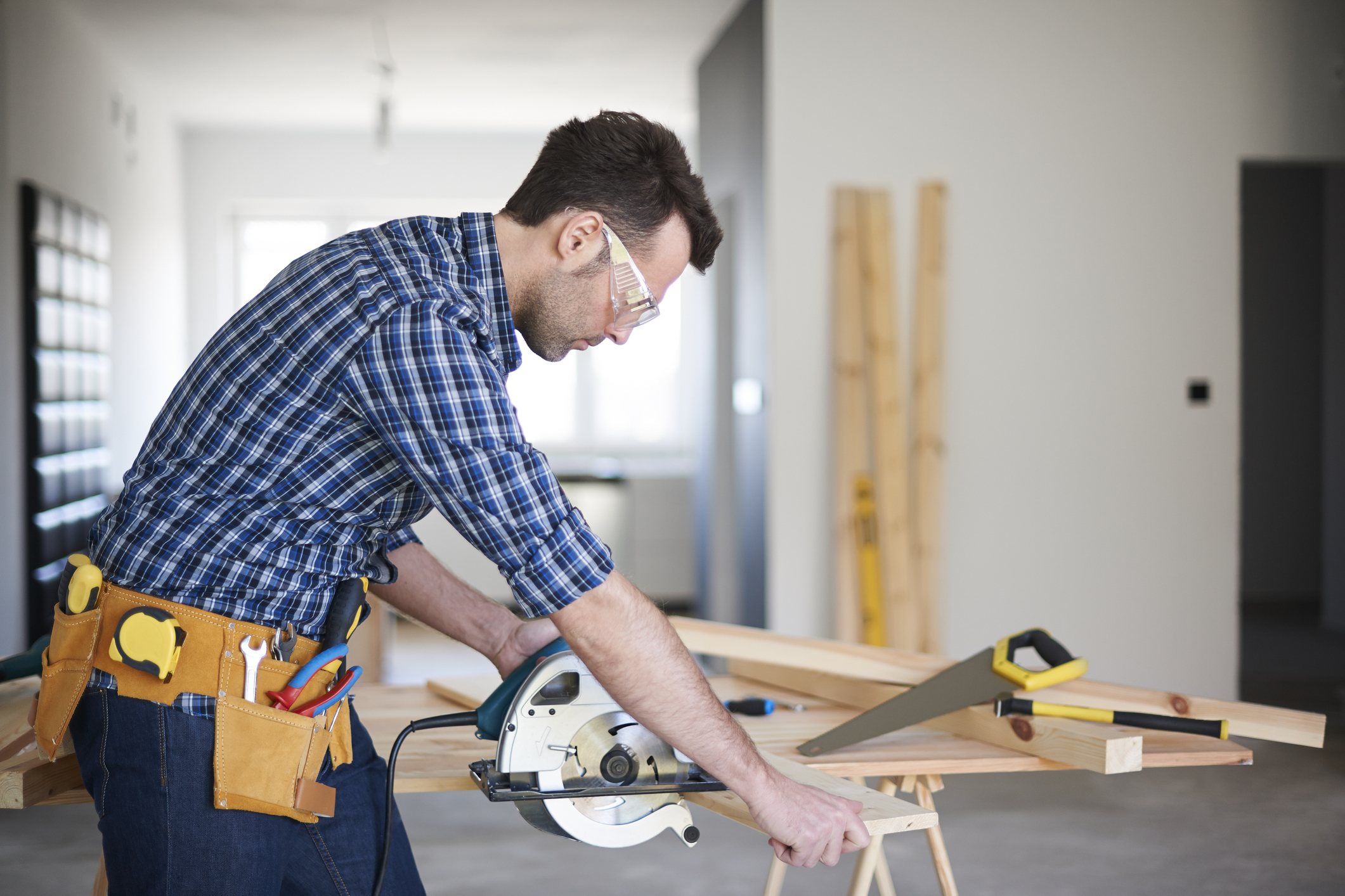 Construction worker or contractor using a saw