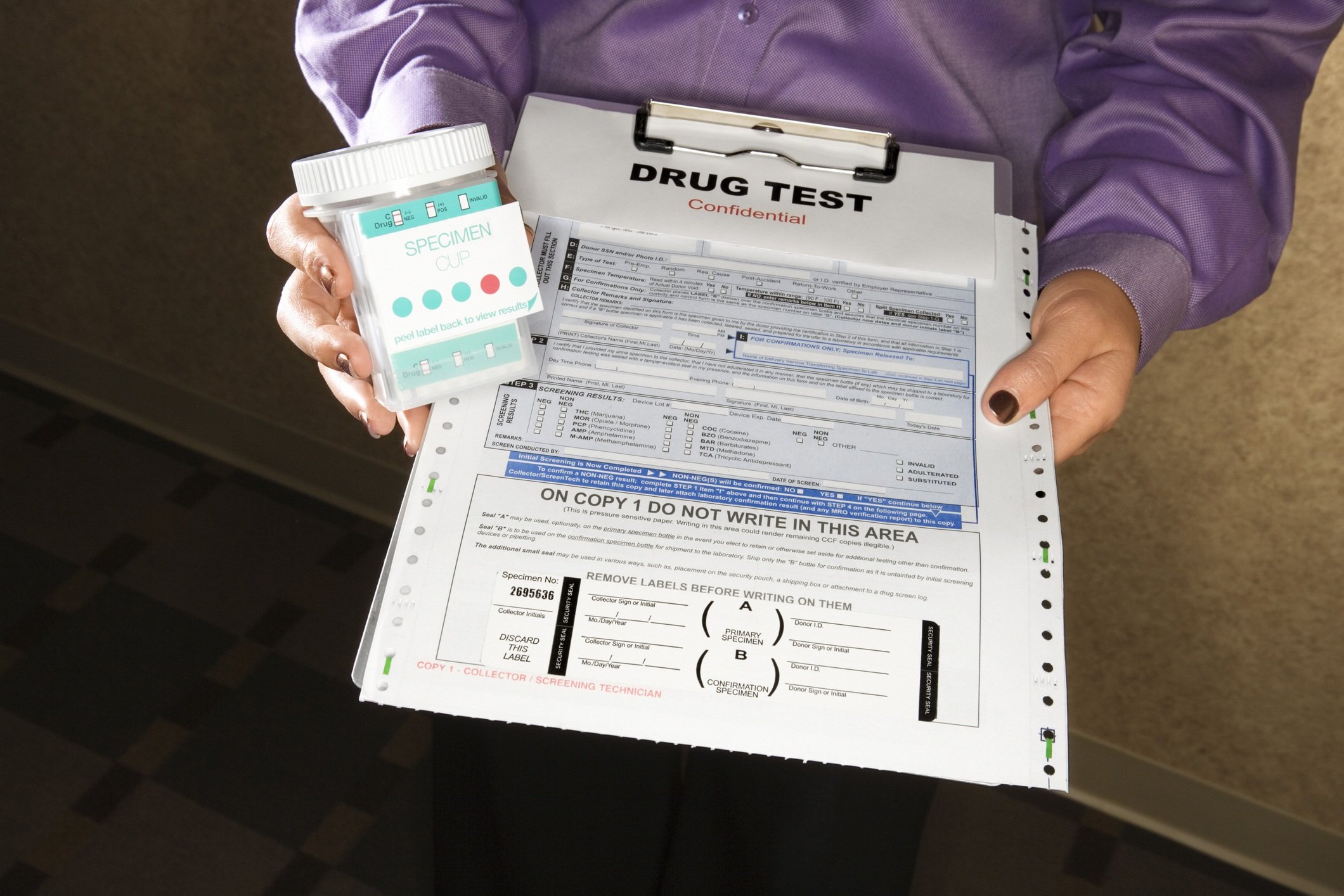 Woman holding clipboard with drug test