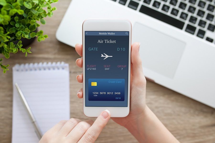 hand holding white phone with online air ticket