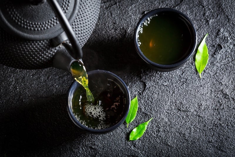 Green tea pouring out of a teapot Green tea pouring out of a teapot