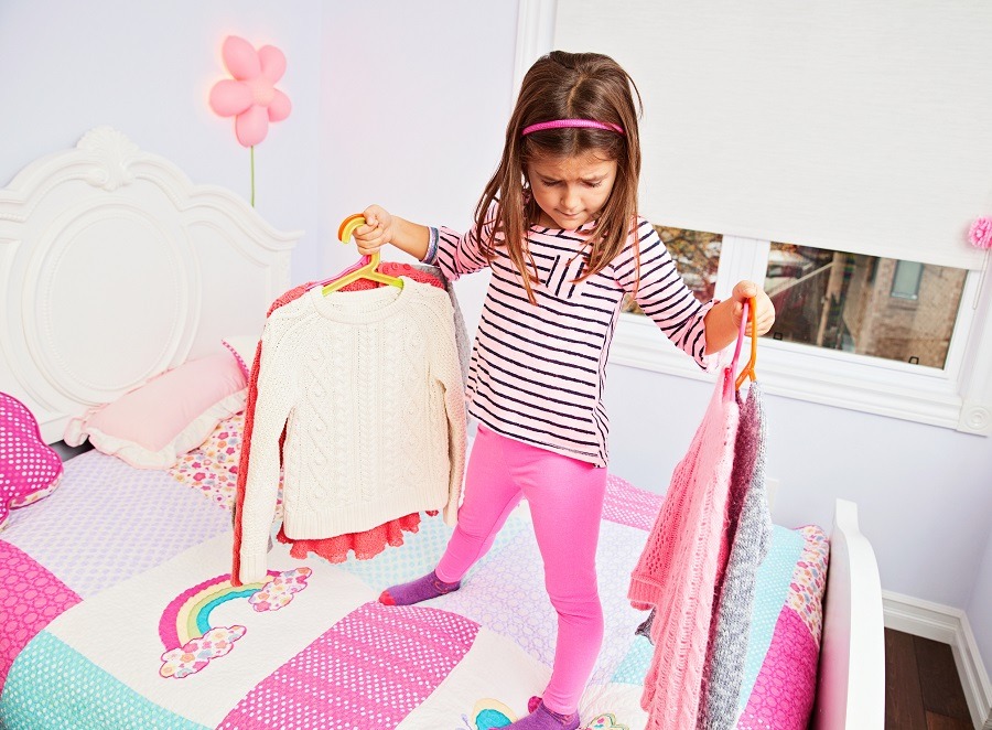 Girl choosing clothes to wear Girl choosing clothes to wear