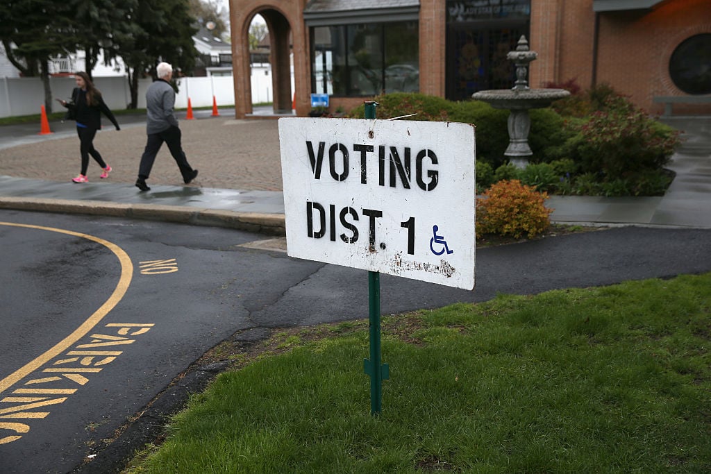 A voter arrives to cast her ballot at a polling center in Stamford, Connecticut.