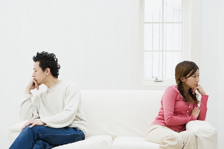 unhappy couple leaning away from each other