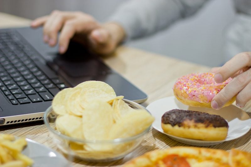 person with doughnuts and chips