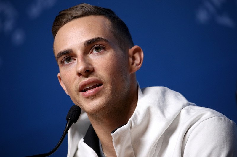 Adam Rippon speaking at a press conference.